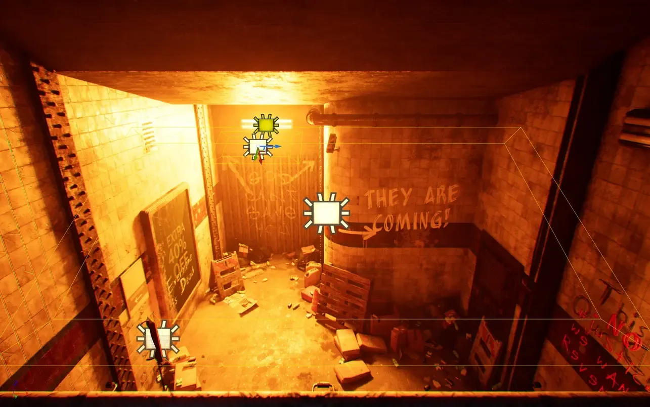 The same spawn room in the editor, showing three added area light icons and a bounding box